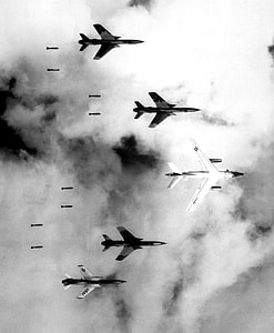  B-66 Destroyer and four F-105 Thunderchiefs dropping bombs in the Vietnam War thumbnail