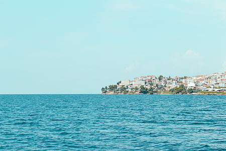 body of water near village at daytime thumbnail