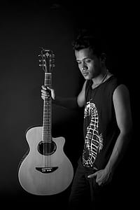 Man Holding Acoustic Guitar thumbnail