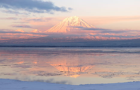 white mountain near body of water thumbnail