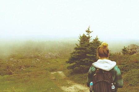 woman walking near green leafed tree thumbnail