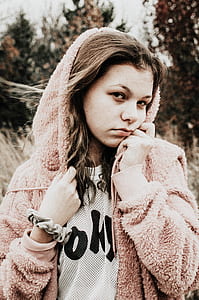 selective focus photography of woman wearing pink fleece zip-up hoodie thumbnail