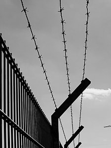 fence with barbed wire greyscale photo thumbnail