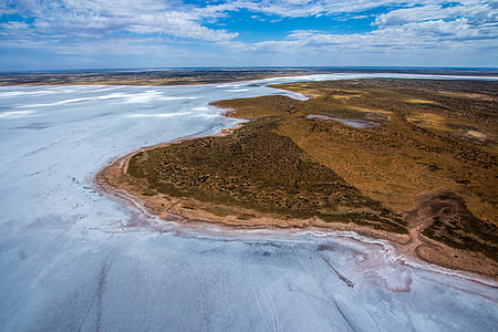 aerial photo of land near body of water thumbnail
