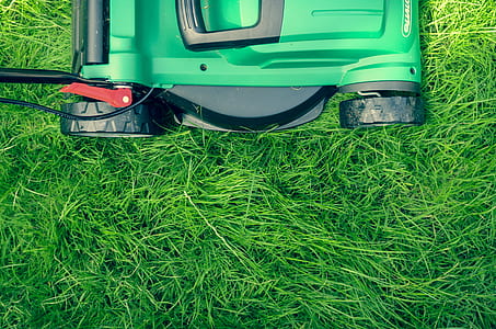 green and black lawn mower on green grass thumbnail