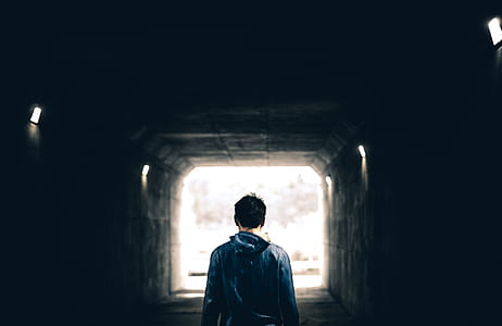 photo of man walking inside tunnel thumbnail