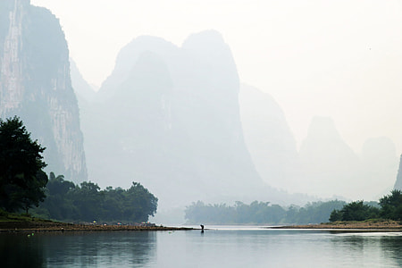 landscape photography of body of water near mountains thumbnail