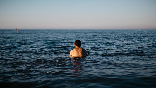 person on body of water during daytime thumbnail