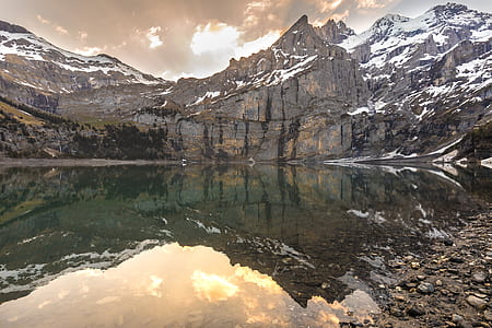 landscape photo of mountain with snow near body of water thumbnail