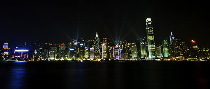 panorama photography of lighted high-rise buildings nearby sea thumbnail