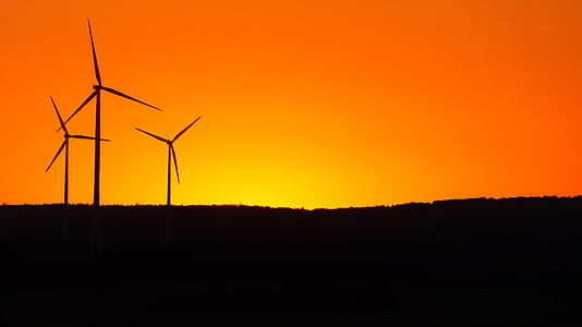 silhouette of wind turbine during golden hour thumbnail