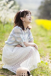 Woman Sitting Near Grass thumbnail