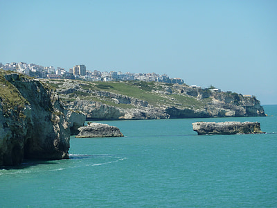 photography of gray rock formations near sea at daytime thumbnail