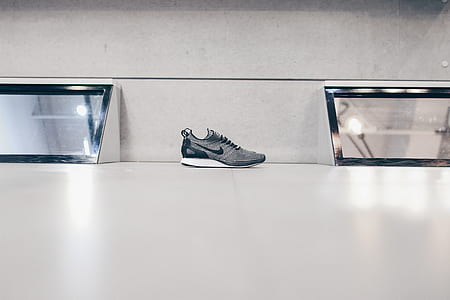 gray Nike running shoes on floor thumbnail