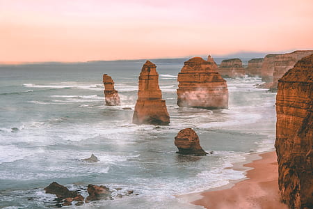 aerial photo of rock formations near body of water thumbnail