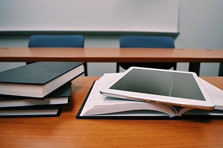 white iPad on book thumbnail