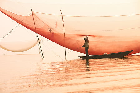 person riding on brown boat thumbnail