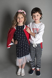 two smiling girls standing inside gray background thumbnail