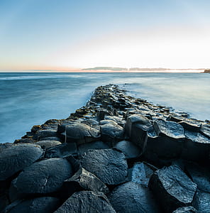 black rocks near body of water thumbnail