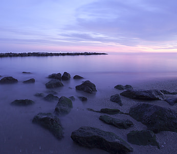 black stones near seashore during daytime thumbnail