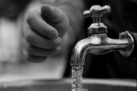 person hands near faucet thumbnail