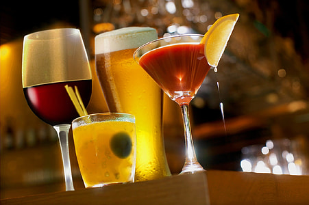 four cups of liquors on wooden surface thumbnail