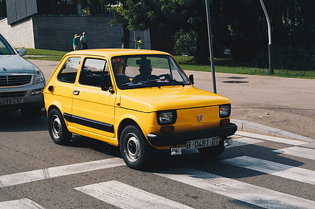 yellow 5-door hatchback on road thumbnail