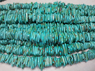 beaded teal accessory on white textile thumbnail