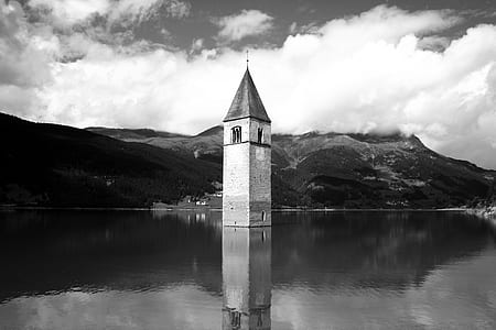 greyscale photography building near mountain thumbnail