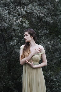 woman standing near tree thumbnail