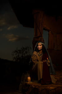 woman sitting next to candle thumbnail