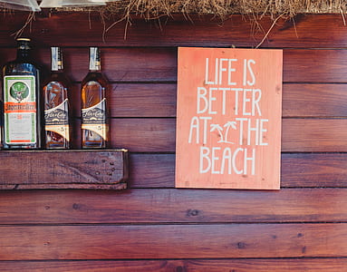 life is better at the beach signage near three liquor bottles thumbnail