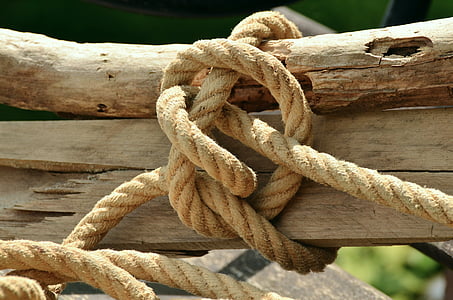 brown rope tied on a brown wooden trunk thumbnail