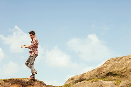 man standing on cliff thumbnail