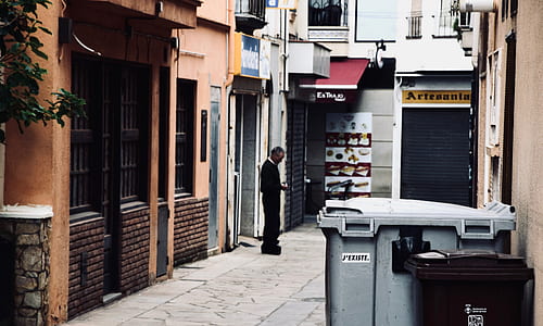 man standing alone outside building thumbnail