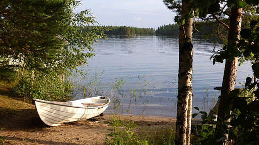 white boat on lake shore thumbnail