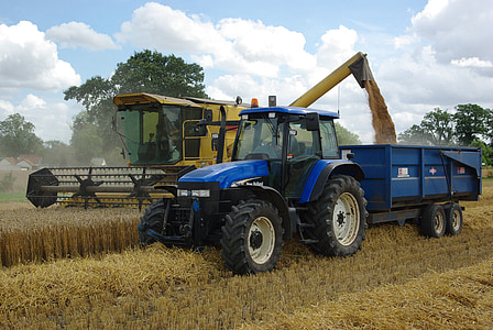 blue tractor beside farm milling machine thumbnail