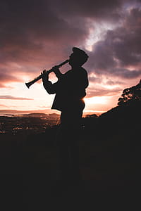 Silhouette Photo Of Person Playing Clarinet thumbnail