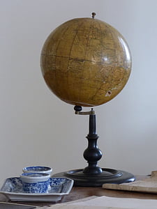 brown and black desk globe on wooden surface thumbnail