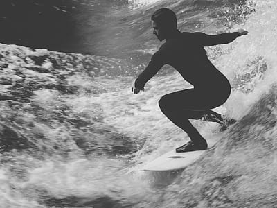 grayscale photo of man riding surfing board thumbnail