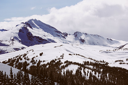 aerial photography of snow-covered field and mountain range thumbnail