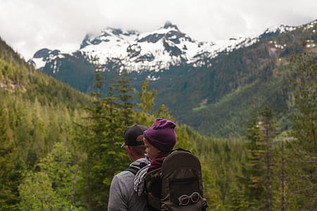 Man Carrying Baby With Brown Baby Carrier Near Trees thumbnail