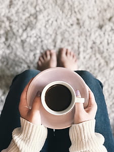 person holding mug with coffee thumbnail