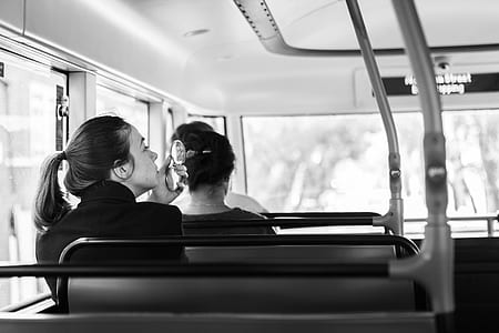 grayscale photo of two women rides on vehicle thumbnail