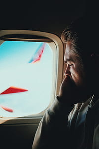 photo of man facing airplane window thumbnail