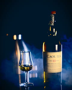 Caol Ila bottle beside clear drinking glass thumbnail