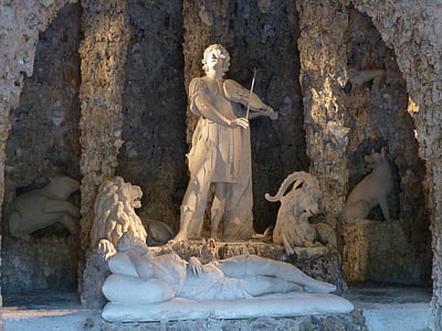 man with violin statue near woman lying statue thumbnail
