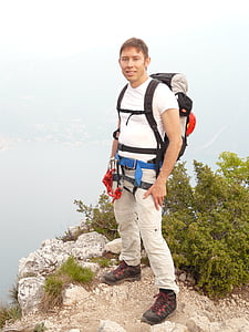 man standing on mountain cliff thumbnail
