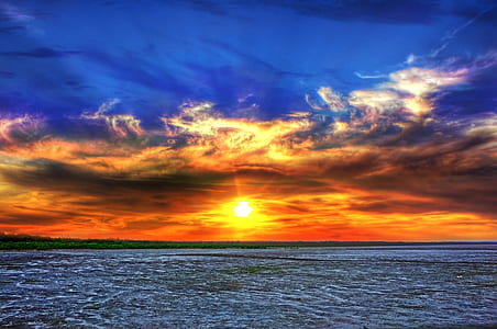 photography of sea under sunset thumbnail