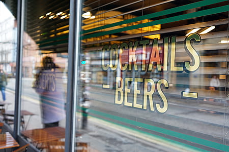 person in white shirt standing beside cocktails beers store thumbnail